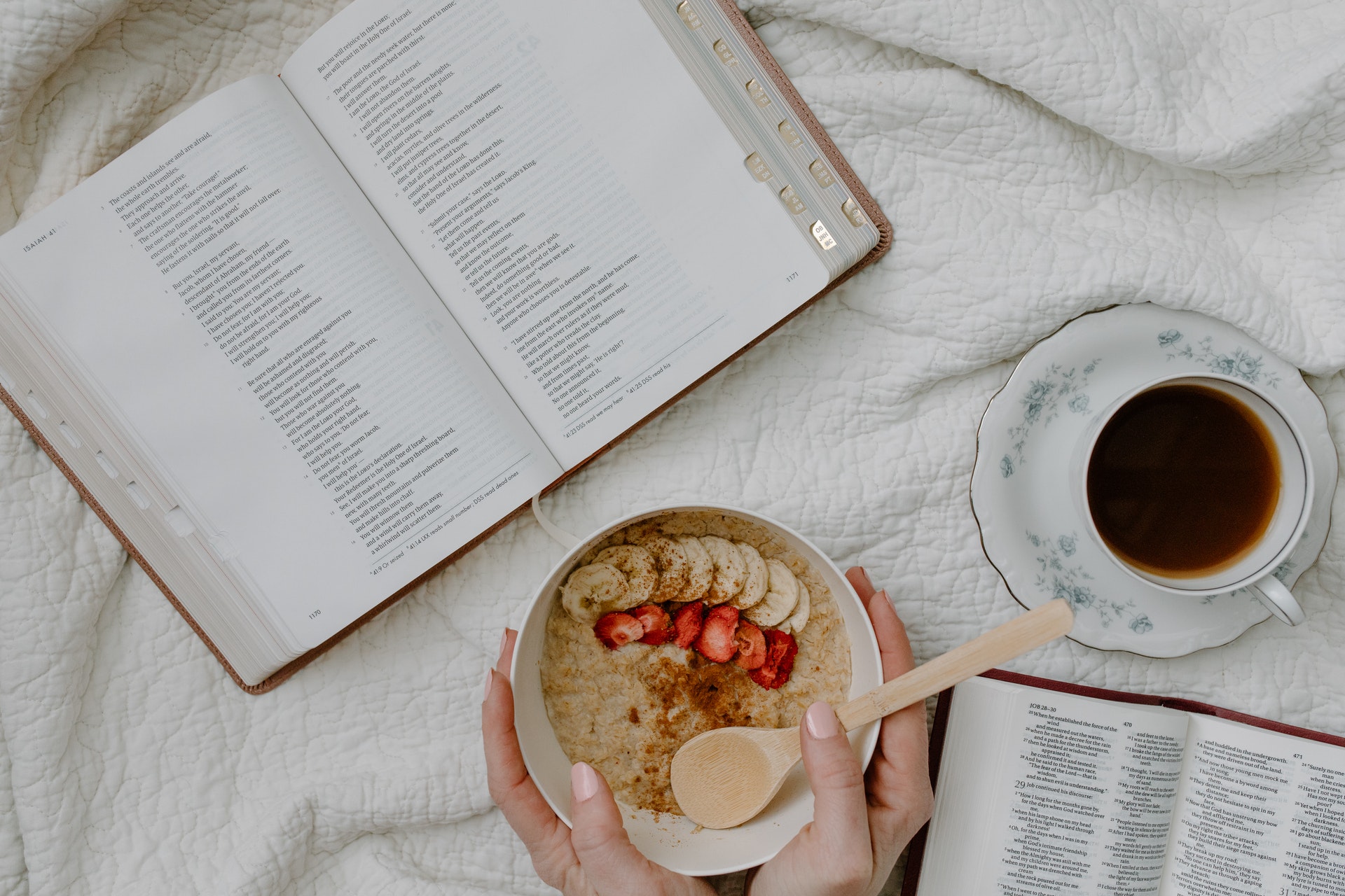 A-bowl-of-oatmeal-with-coconut-milk-next-to-a-cup-of-coffee-